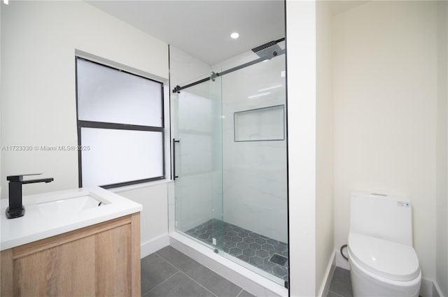 bathroom featuring tile patterned floors, vanity, an enclosed shower, and toilet