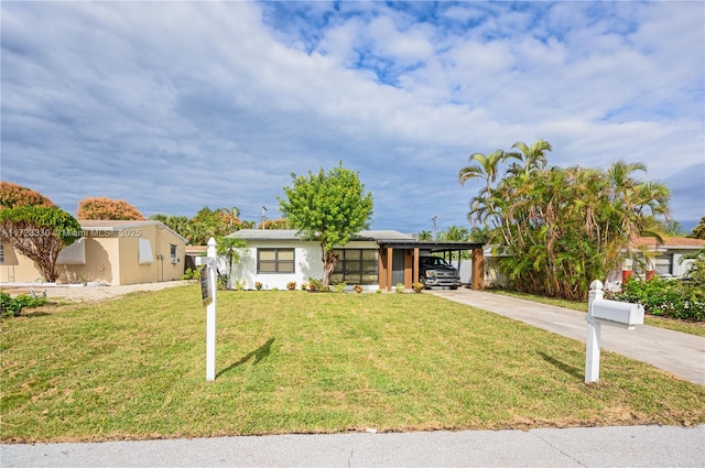 view of front facade with a front lawn and a carport