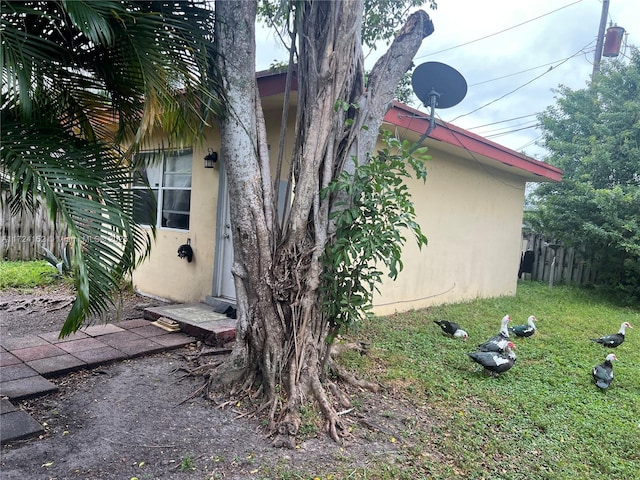 view of side of home featuring a lawn