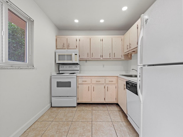 kitchen with sink, light tile patterned floors, light brown cabinetry, and white appliances