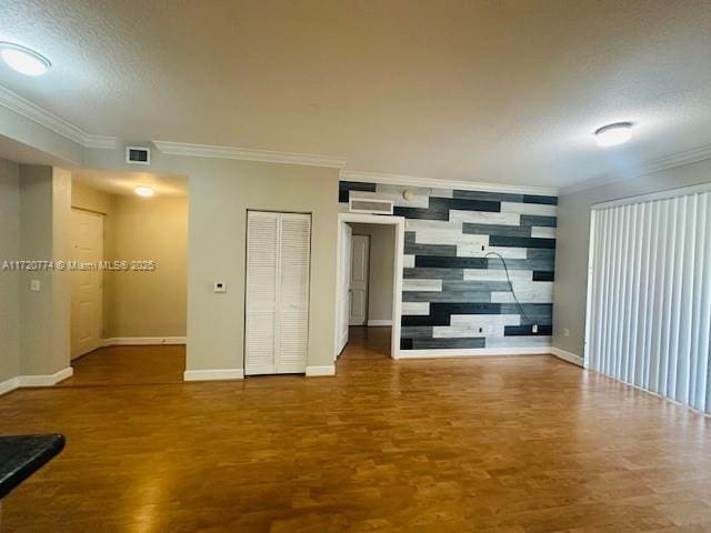 spare room with a textured ceiling and hardwood / wood-style flooring