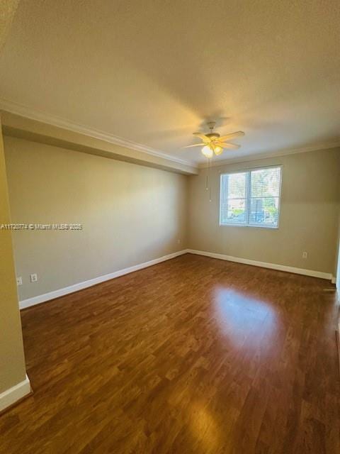 empty room with a textured ceiling, dark hardwood / wood-style floors, ceiling fan, and crown molding