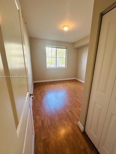 unfurnished room featuring wood-type flooring