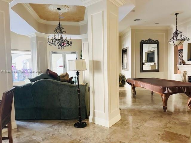 interior space featuring a raised ceiling, crown molding, a chandelier, and pool table