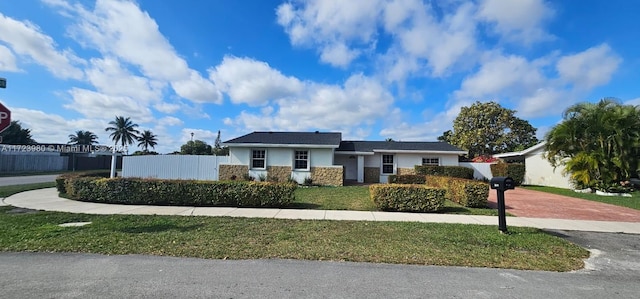 ranch-style home with a front yard