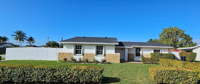 rear view of property featuring a lawn