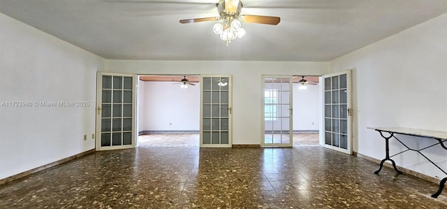 spare room featuring ceiling fan and french doors