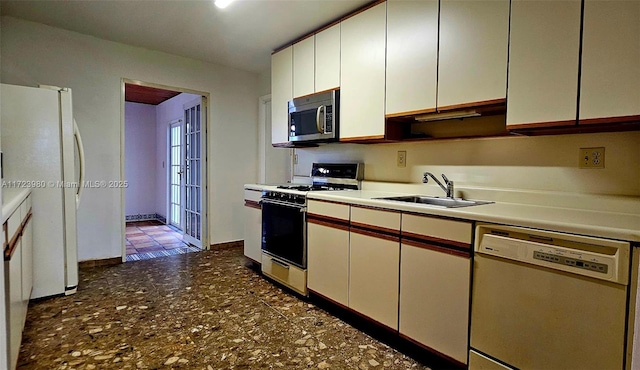 kitchen with white cabinetry, sink, and white appliances