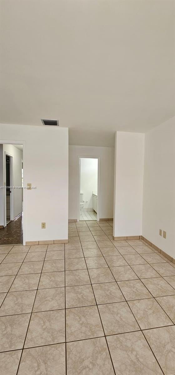 empty room with light tile patterned floors