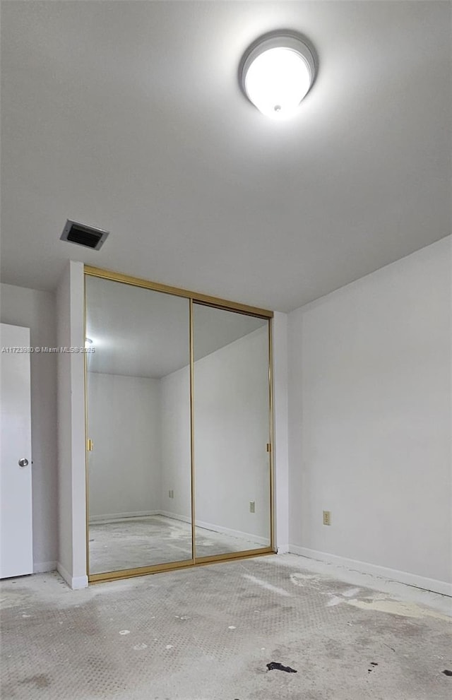 unfurnished bedroom with carpet floors and a closet