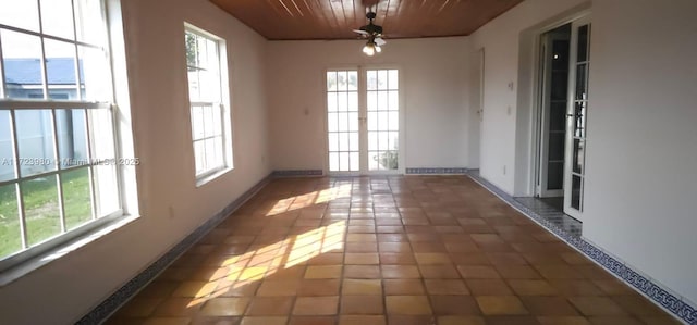 interior space featuring ceiling fan and dark tile patterned floors