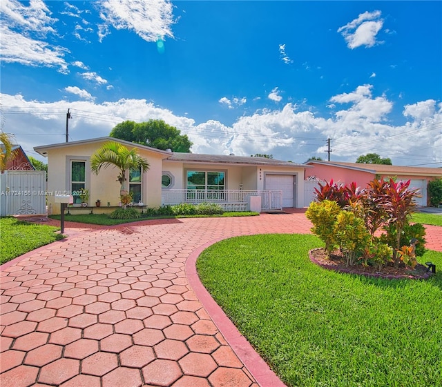 ranch-style home featuring a garage and a front lawn