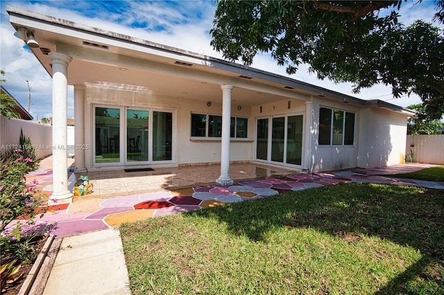 rear view of property with a patio area and a yard