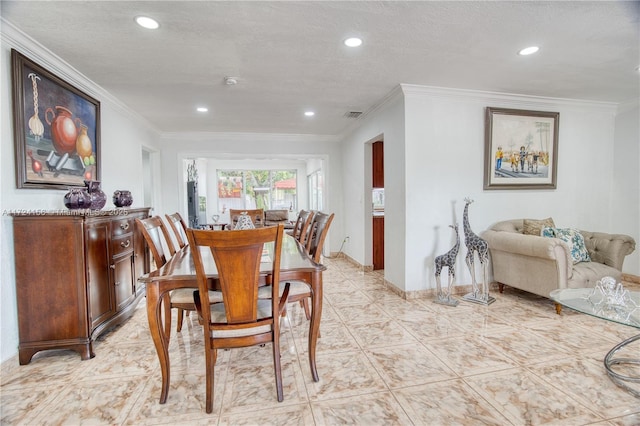 dining area featuring a textured ceiling and crown molding