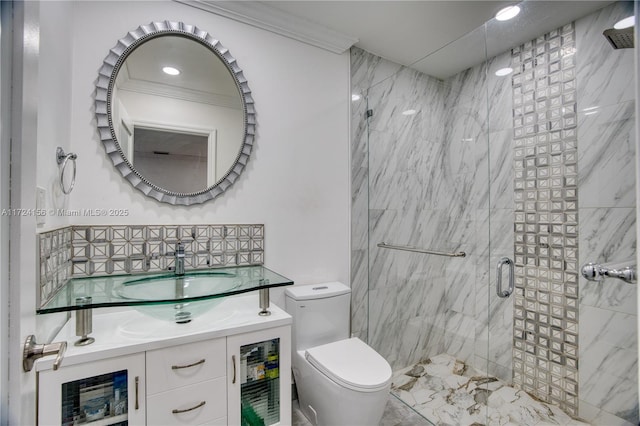 bathroom with vanity, toilet, ornamental molding, and walk in shower