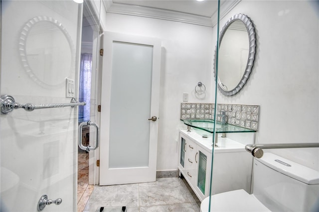 bathroom with tile patterned flooring, vanity, toilet, and crown molding