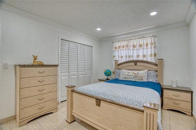 bedroom featuring crown molding, a closet, and light tile patterned floors