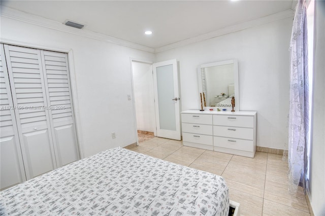 tiled bedroom featuring a closet and ornamental molding