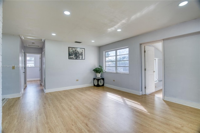 unfurnished room featuring a wealth of natural light and light hardwood / wood-style flooring