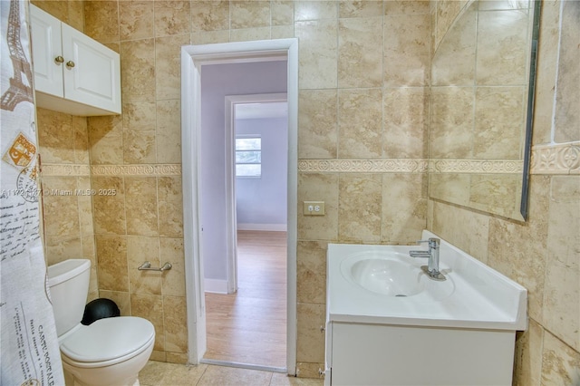 bathroom with vanity and tile walls