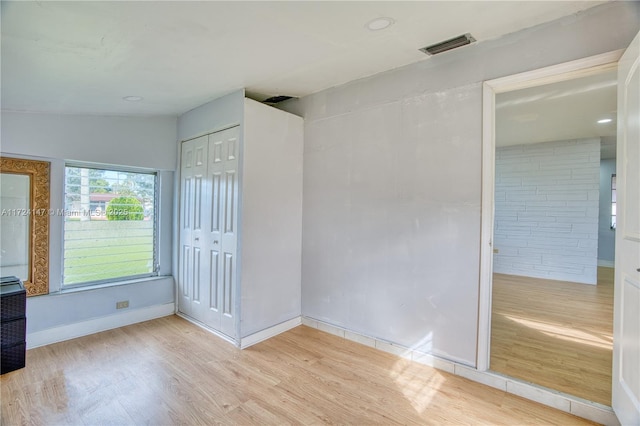 unfurnished bedroom with a closet and light hardwood / wood-style floors