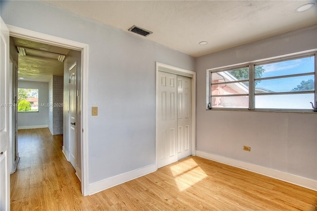 unfurnished bedroom featuring a closet and light hardwood / wood-style flooring