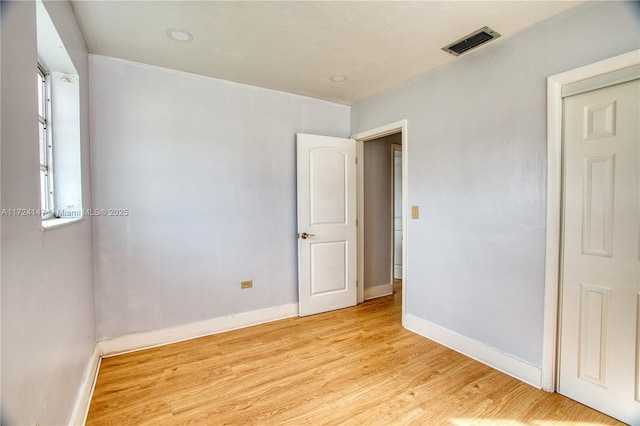 spare room featuring light wood-type flooring