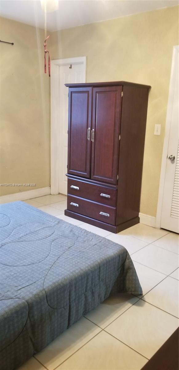 bedroom featuring light tile patterned floors