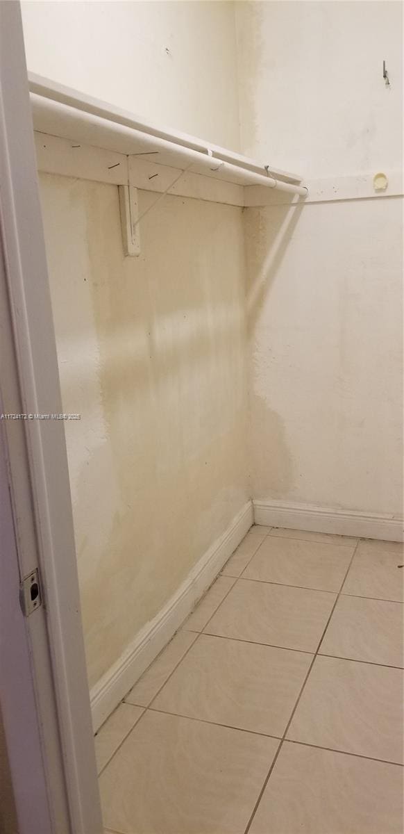 spacious closet with light tile patterned floors