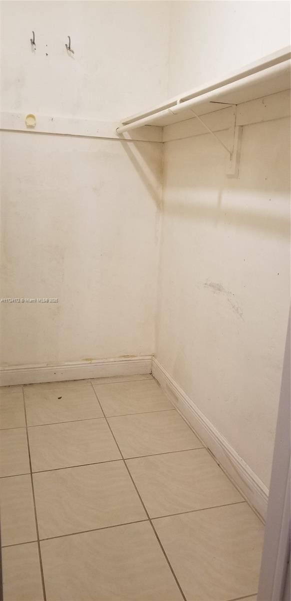 spacious closet featuring light tile patterned flooring