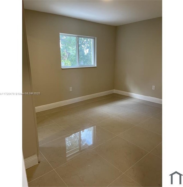 spare room featuring light tile patterned flooring