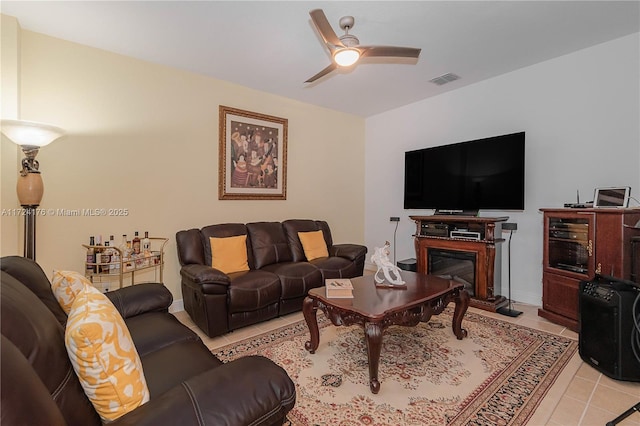 living room featuring light tile patterned flooring and ceiling fan