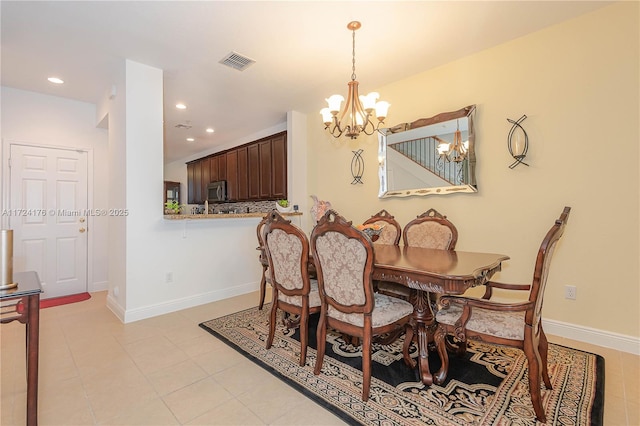 dining space with an inviting chandelier