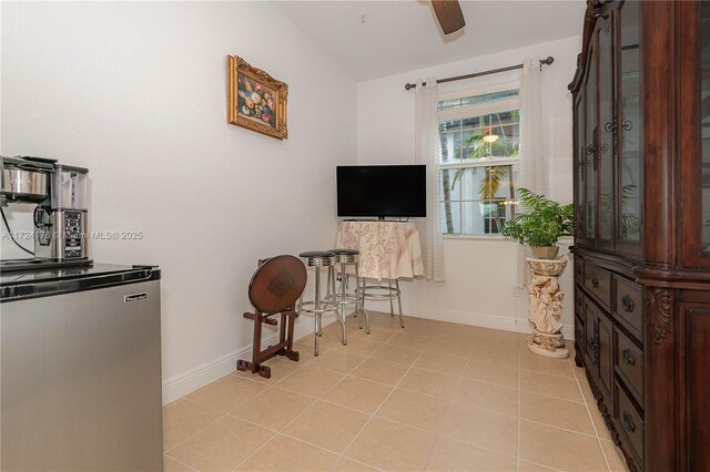 interior space featuring ceiling fan and light tile patterned floors