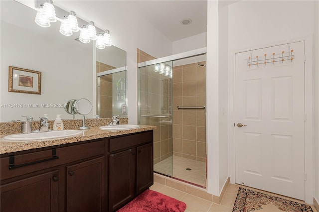 bathroom featuring vanity, an enclosed shower, and tile patterned flooring