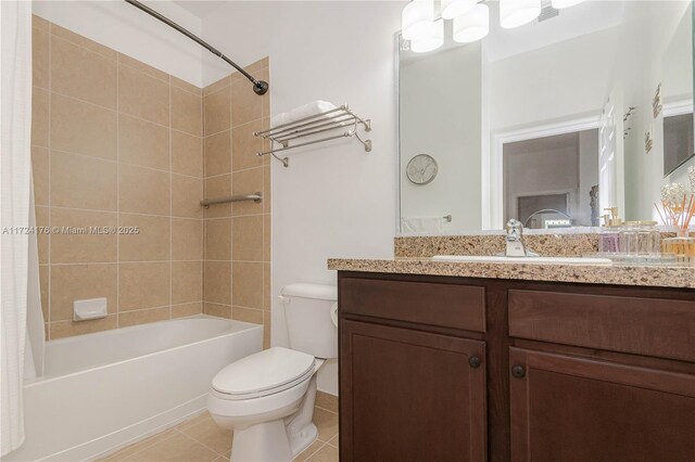 full bathroom with vanity, shower / bath combination with curtain, tile patterned floors, and toilet