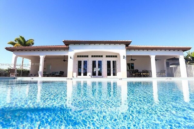 back of house featuring a patio area, ceiling fan, and a community pool