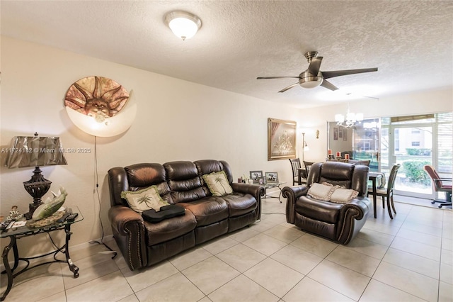 living room with ceiling fan with notable chandelier, light tile patterned floors, and a textured ceiling