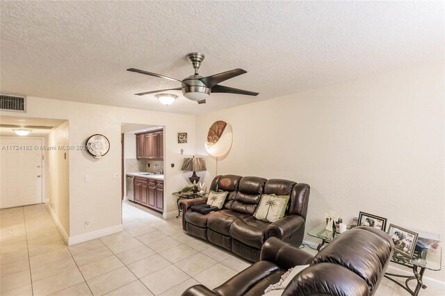 1251 SW 125th Ave Unit 108T, Pembroke Pines, FL 33027 - living room with visible vents, a ceiling fan, light tile patterned flooring, and a textured ceiling