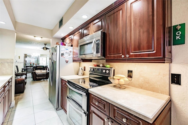 kitchen featuring light tile patterned floors and stainless steel appliances