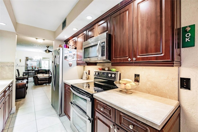 kitchen featuring ceiling fan, light tile patterned floors, visible vents, light countertops, and stainless steel appliances