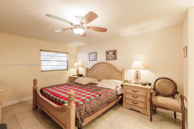 tiled bedroom with ceiling fan and a textured ceiling