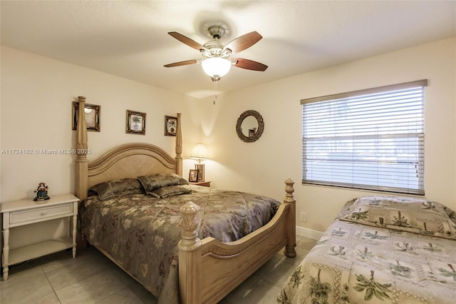 bedroom with light tile patterned floors, baseboards, and ceiling fan
