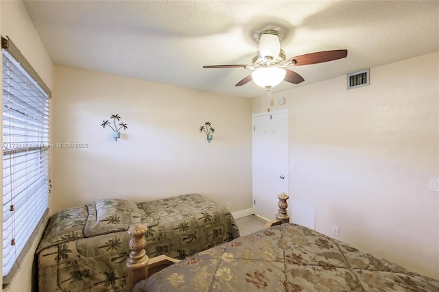 tiled bedroom featuring ceiling fan