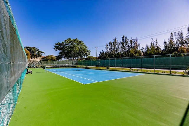 view of sport court featuring fence