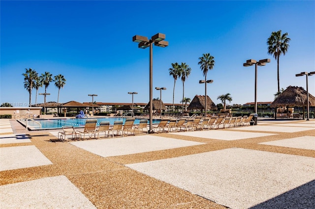 surrounding community with a gazebo, a patio area, and a pool