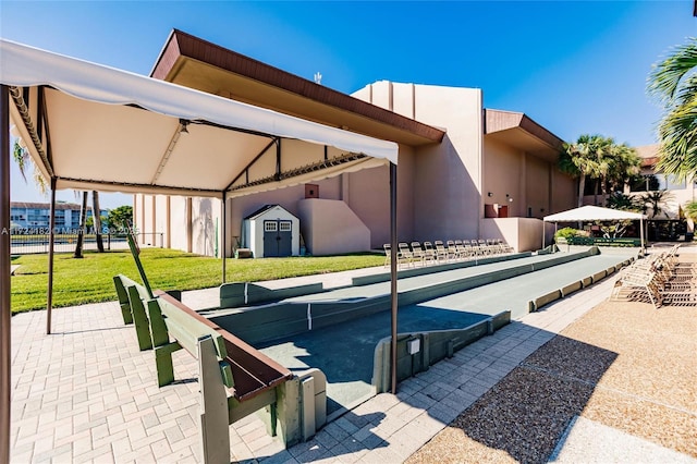 view of pool featuring a yard and a storage unit