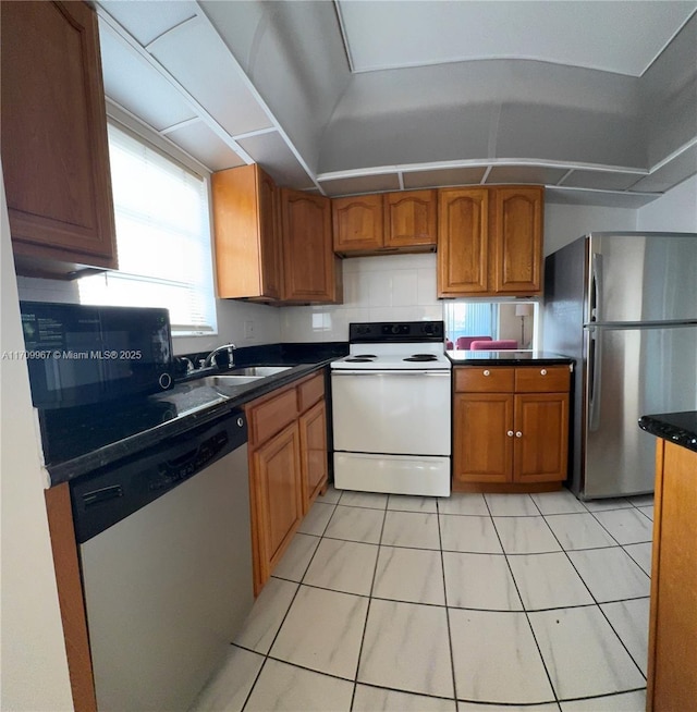 kitchen with sink, light tile patterned floors, and stainless steel appliances