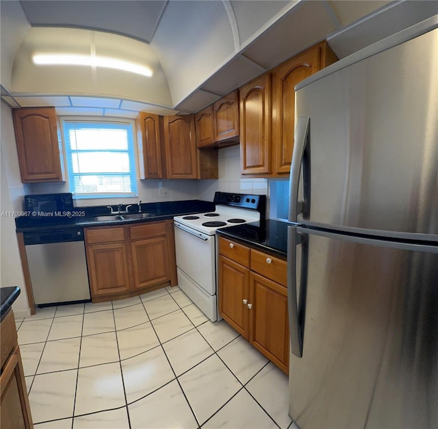 kitchen with sink, light tile patterned floors, and stainless steel appliances