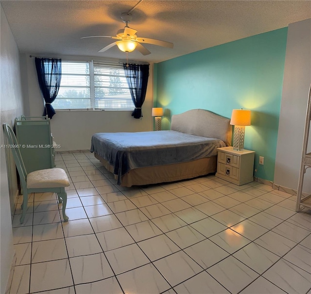 tiled bedroom with a textured ceiling and ceiling fan